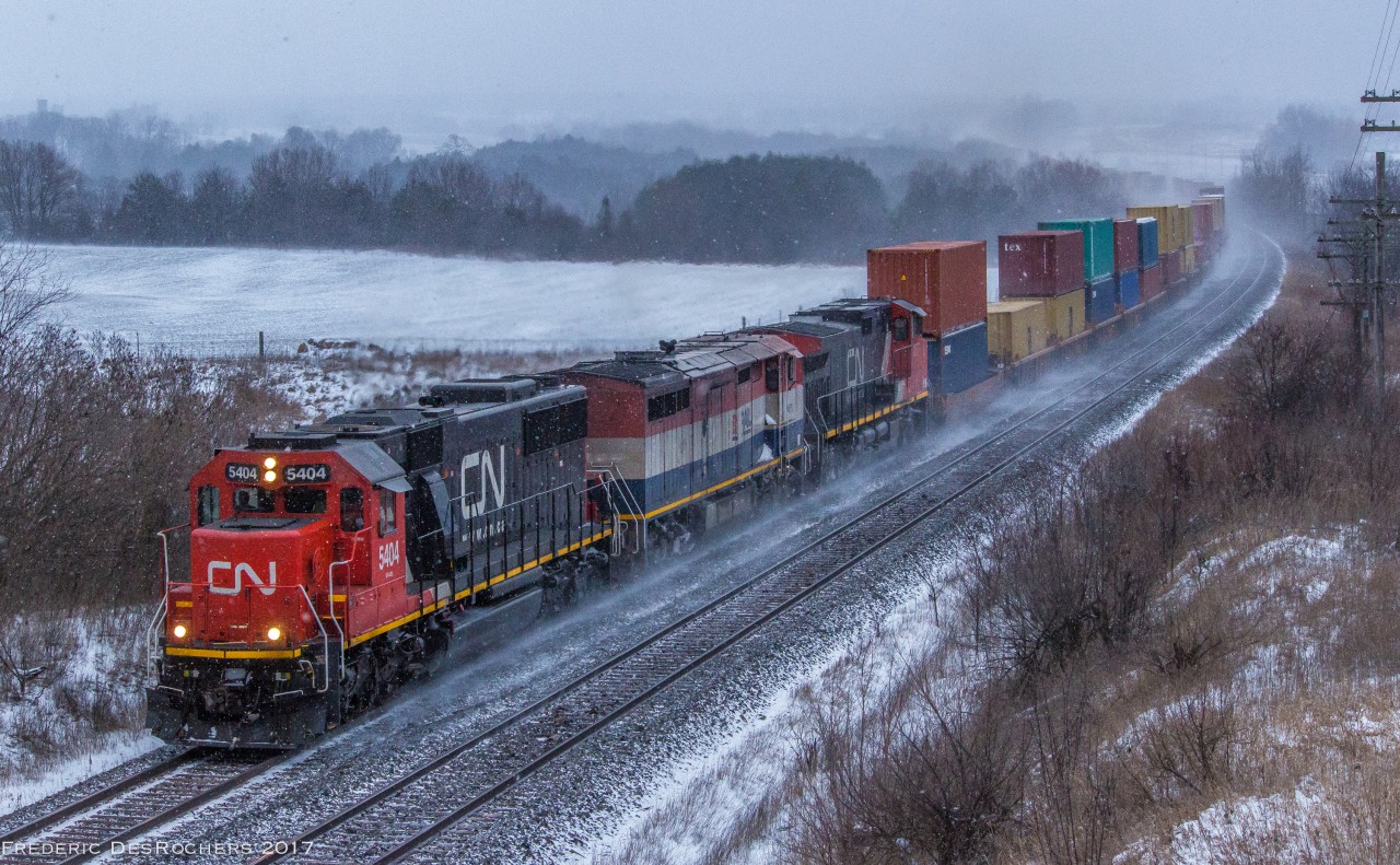 During a small snow squall, CN 149 comes through Newtonville with a clean SD60 leading the way.

CN 5404, BCOL 4611, CN 2677