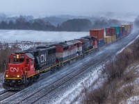 During a small snow squall, CN 149 comes through Newtonville with a clean SD60 leading the way.

CN 5404, BCOL 4611, CN 2677 