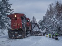 The CN spreader heads North through Utterson, next to some rather confused snowmobilers. 
