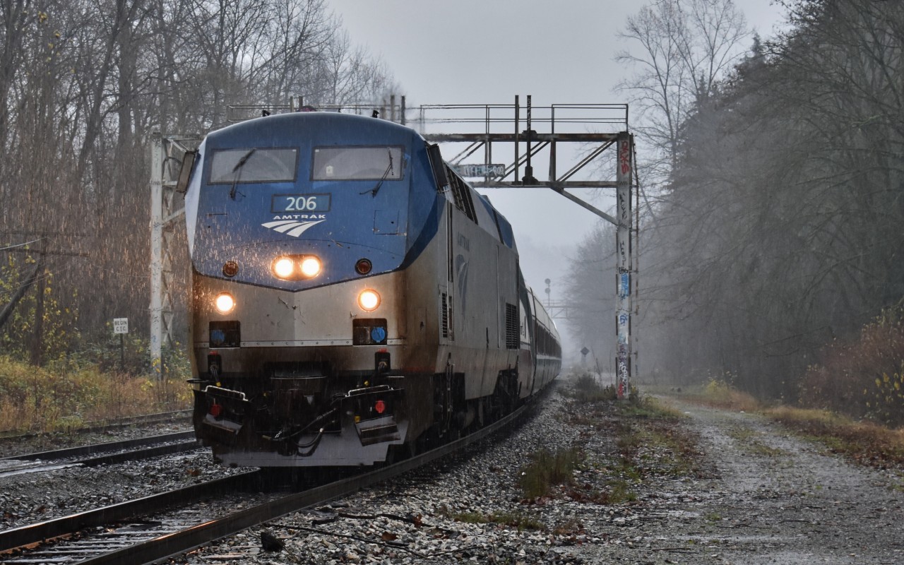 In a very Pacific Northwestern scene, Amtrak 206 hustles through fog, rain, and wind past Lake City in Burnaby, BC, as it hauls the northbound Cascades on the last leg of its journey into Vancouver.