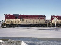 GP-7 #74 leads a phosphate train through the yard at Port Maitland on February 28, 1982.  This would be a pretty routine broadside of a GP-7 without the TH&B lettered crossing sign.