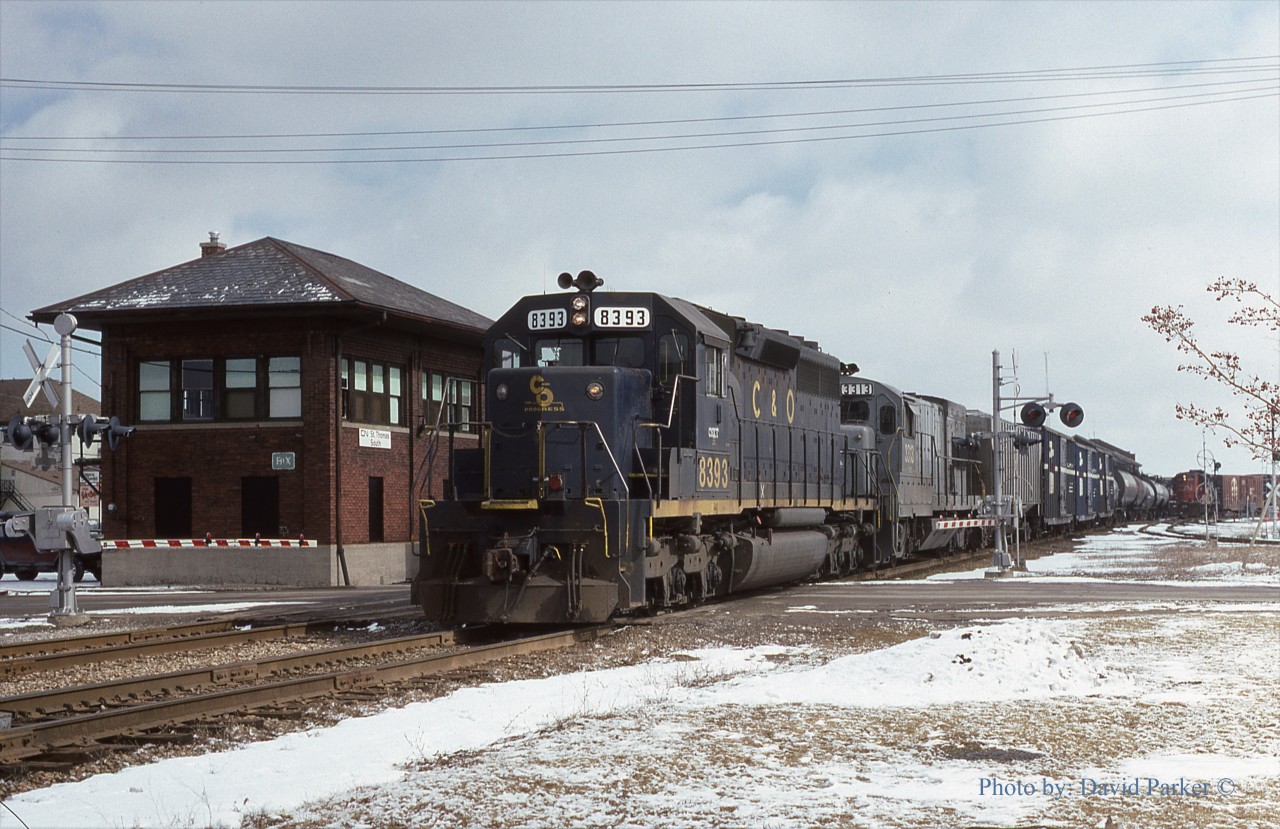 Busy times at "BX"...CSX #321 departs St. Thomas led by ex C&O SD40 8393 and ex L&N U23B 3313 while a CN GP9 switches the yard on March 1st 1988.