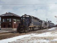 Busy times at "BX"...CSX #321 departs St. Thomas led by ex C&O SD40 8393 and ex L&N U23B 3313 while a CN GP9 switches the yard on March 1st 1988. 