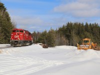 With 38 loaded cars of nickel ore, ex-Soo locomotives 6259 and 6230 slowly crawl up the hill from Levack and back to the rails of the Cartier Sub.  The MOW equipment on the right always comes in handy with this section of track in the winter months.
