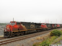 A wave from the conductor as a grimy GEVO leads 120's power up the small grade and out of the HIT after dropping intermodal cars.