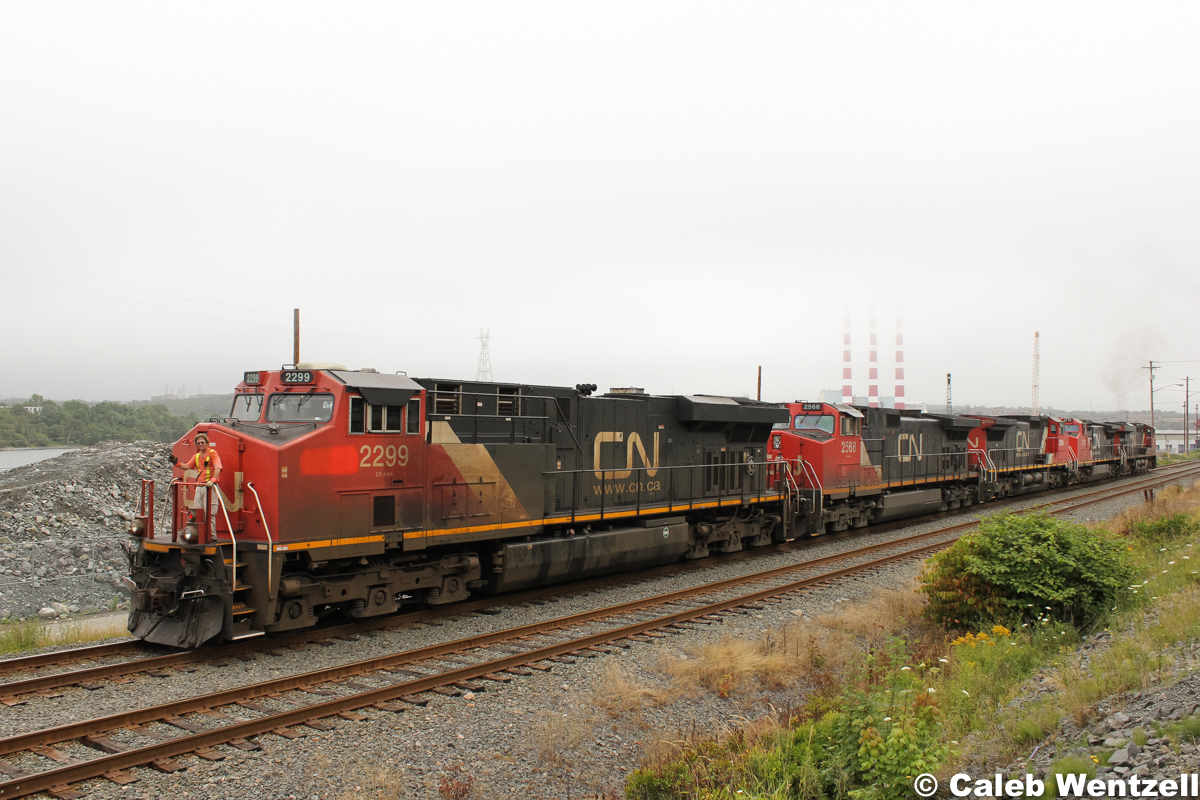 A wave from the conductor as a grimy GEVO leads 120's power up the small grade and out of the HIT after dropping intermodal cars.