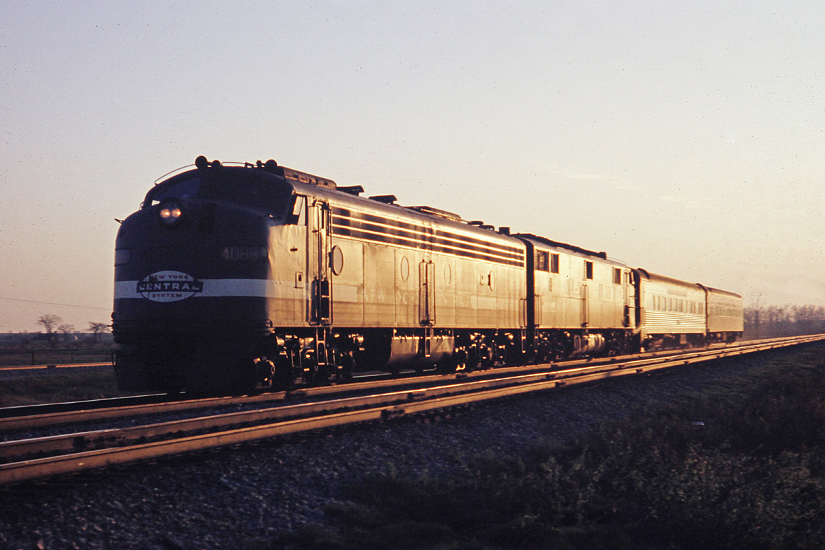 2 E's, 2 coaches.  The sun glints off a pair of NYC E-units as we approach sunset in May 1968.  Check out the second unit.