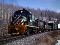 March of 1985 the WP (Williams Lake -Prince George) freight has just completed some switching chores at the Dunkley Lumber sawmill located at mile 413.6 on the BC Rail Prince George subdivision. While waiting for the train air to settle, I stood on the roadbed and captured this image. Shortly after this picture was taken, we would continue our journey north to Prince George BC, take some rest and then return trip to our home terminal of Williams Lake.  Dunkley Lumber was an interesting place to switch, there was a lumber loading track with north connection only and a wood chip track with south end connection. The lumber track held six cars and the chip track held fifteen or so wood chip cars. Quite often we would have to "pull and supply" both tracks and this would involve several run around moves in the small siding adjacent to the main track. The siding only held ten cars and to compound the switching headache there was a road crossing to be manually protected by a crew member. Dunkley Lumber was a very modern, high production mill and a valued customer of BC Rail.
