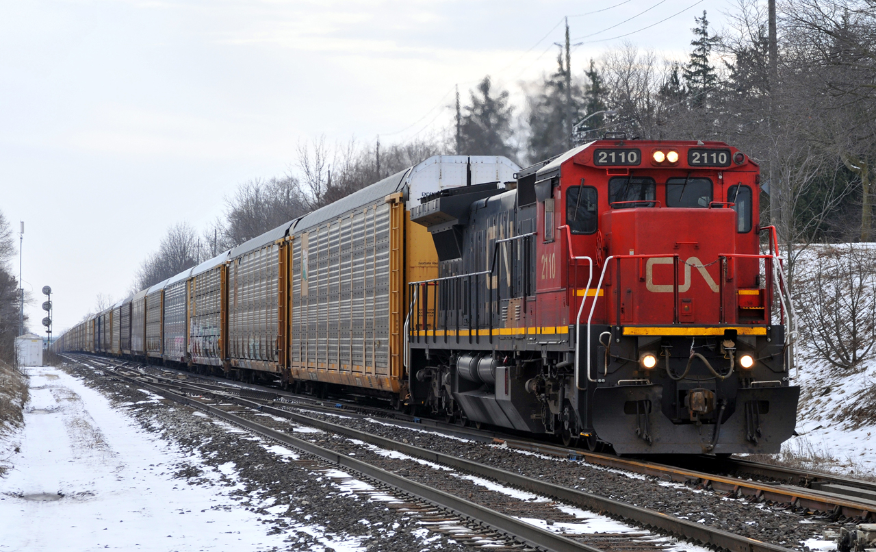 M37131 11 struggling up the grade at Hardy with CN C40-8 2110, and 70 autoracks on the drawbar
