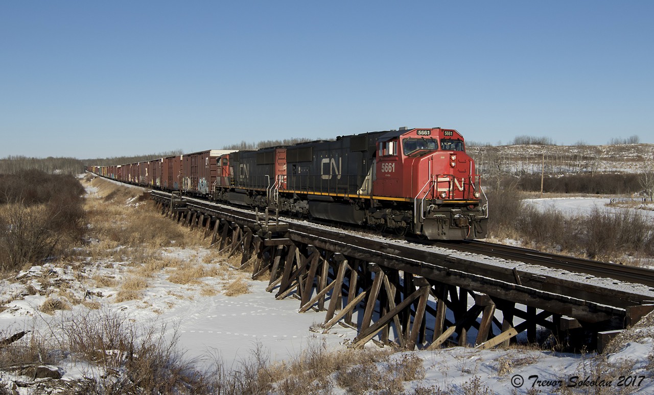 Fort MacMurray to Edmonton freight L556 crosses over a low wooden trestle near Redwater Alberta