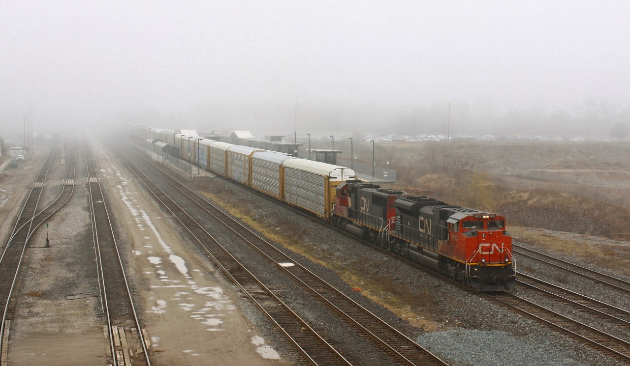 The fog and CN 8012 simultaneously roll into Aldershot on a dreary Friday afternoon. The train 371, one I'm not too familiar with, is a unit autorack train 94 cars long. I initially thought that the crew dimmed the ditch lights for me to help with the photo quality, which brought a smile to my face. However when 148 went by on track 2 seconds later I realised it probably wasn't for me! 

On a side note, CN and GO were having a rough day. A power outage somewhere cause a great deal of both dispatching systems to go down for over an hour, causing huge delays. Things seemed to be back to normal at the time of this photo, however when I was topping up my Presto card in the station there was a gentleman attempting to get compensation for having to wait an hour at Union.