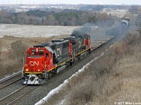 Not typical of CN freights, 5452 and 2560 lead 517's 15 car train through the sag at Newtonville. 1357hrs.