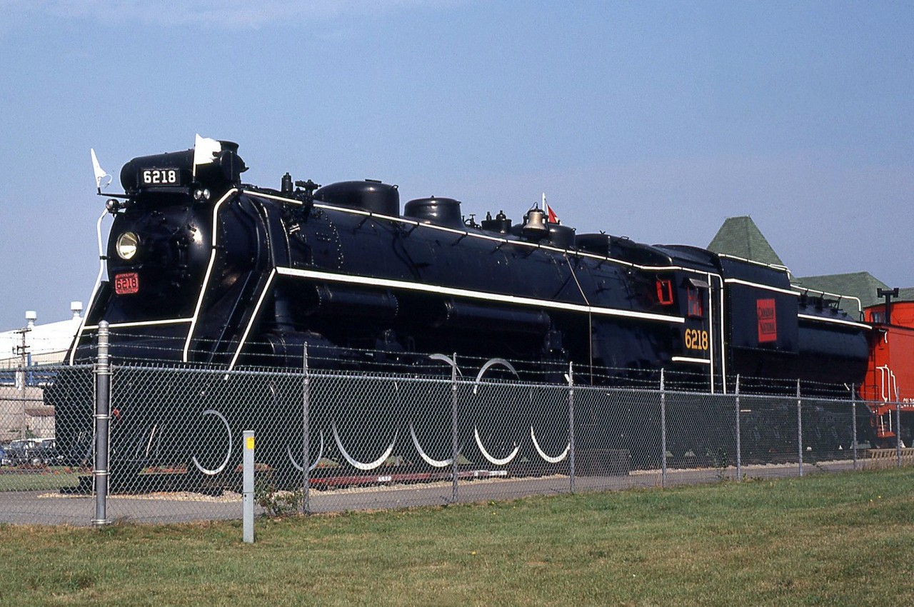 Black paint, white flags and brass bell gleaming in the sun, Canadian National U2g Northern 6218 sits proudly on display in Fort Erie in August of 1980, after her donation to the town in 1973 by CN.