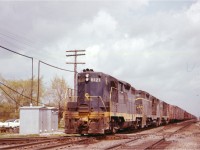A westbound Chesapeake & Ohio freight is shown at Canfield in May 1961, lead by C&O GP9 6121 and two other first-generation Geeps.