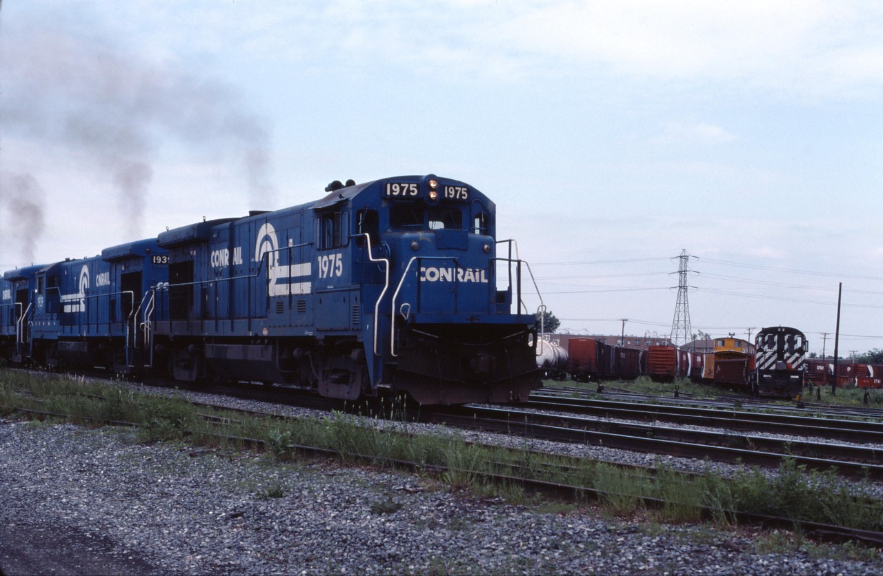 Conrail's St-Luc (Montreal)-Selkirk, NY freight is about to leave the island of Montreal and cross the St. Lawrence River. In less than 2 miles it will leave CP Rail and enter Conrail track at Adirondack Jct.

With CP's purchase of the D&H in 1991 and Conrail's purchase of most of CN's line to Huntingdon in 1993 (now operated by CSX), the traditional routing to Montreal lost favour and the line between Adirondack Jct. and Beauharnois is now out of service.