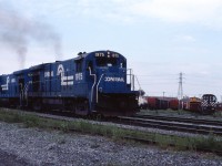 Conrail's St-Luc (Montreal)-Selkirk, NY freight is about to leave the island of Montreal and cross the St. Lawrence River. In less than 2 miles it will leave CP Rail and enter Conrail track at Adirondack Jct.

With CP's purchase of the D&H in 1991 and Conrail's purchase of most of CN's line to Huntingdon in 1993 (now operated by CSX), the traditional routing to Montreal lost favour and the line between Adirondack Jct. and Beauharnois is now out of service.

