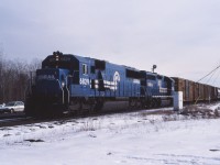 Back onto its normal routing, Conrail's Selkirk Yard to Montreal (CP St-Luc) train approaches the St. Lawrence Seaway crossing and the bridge onto the island of Montreal. The train is now led by big six-axle units such as SD50 6829, unlike the smaller power used in prior years.

Today, the 6829 has been retired by Norfolk Southern and the former Conrail line through Adirondack Jct and Chateauguay is quiet with CSX traffic operating through Valleyfield.