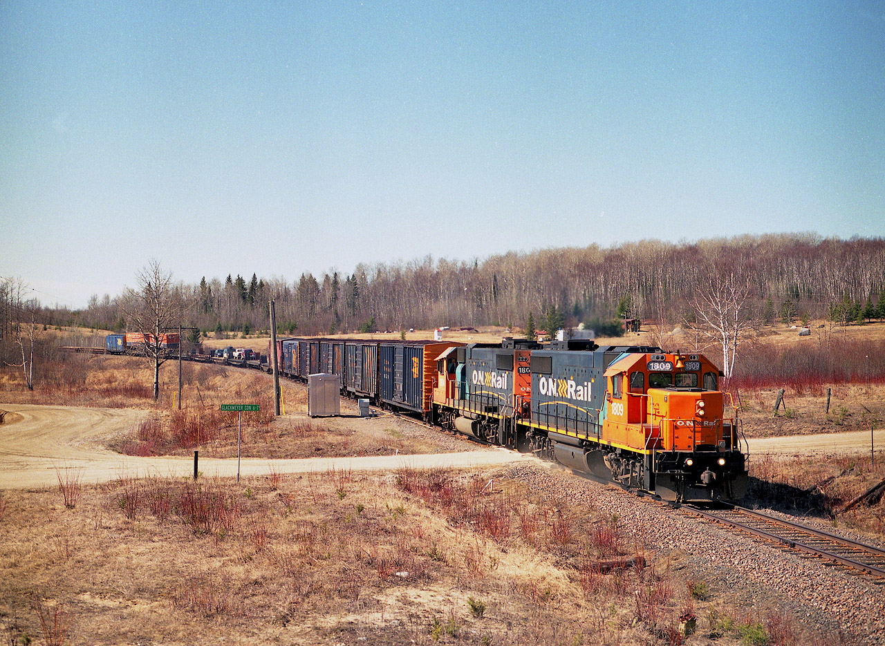 Where? Larocque. Well, I had never heard of it either, but the beauty of these modern day maps is I no longer have to dig out the old topographical maps to find where I have been or where I am going. They still accompany me on trips though. (I had marked this image at being shot at 'Clute') This is the ONR "Little Bear" on its way to Moosonee with the standard mixed train. Some of you 'Northern guys' are no doubt very familiar with this location, Glackmeyer Con 6-7 as indicated on the sign, one of the last decent shooting spots before the train is into the wilderness. Its a longer train than I expected, unfortunately, which leaves the coaches and the flats carrying autos and equipment mostly out of sight in this photo. Power up front is ONR 1809, 1804.