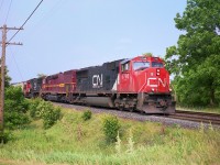 Sandwiched between these CN SD75s is  Duluth, Missabe & Iron Range (DMIR)#403, now a SD40-3; a rare treat in Southern Ontario. I saw this unit go by when in Dundas, and gave chase just because I may not see one along this line again. And I never did, other than units done over in CN. I would imagine they are all now sporting their CN jackets, and according to CTG there are but 9 left of the original 20 in this series. The DMIR was acquired by CN two years before this photo was taken. Power is CN 5796, DMIR 403 and CN 5729.