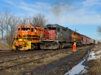 GEXR 431 throttles up out of Guelph with a puff of exhaust as the crew of GEXR 582 gives a roll-by inspection.  The 2-unit locomotive set on 431 was quite a difference from the 5-units up front just 2 days prior (<a href="http://www.railpictures.ca/?attachment_id=28414">http://www.railpictures.ca/?attachment_id=28414</a>).  432 left Stratford with 3 units (3394, 3393, 3054) but was stopped by the detector at mile 56.2.  The bearing on the #1 axle on the 3393 was worn and overheating.  The crew set off the unit (in the siding nearest the photographer; at the far end though) and continued with the 2 units.<br><br>A foreman arrived shortly to repair the unit, and GEXR 580 towed it to Kitchener for GEXR 432 to lift the next morning.