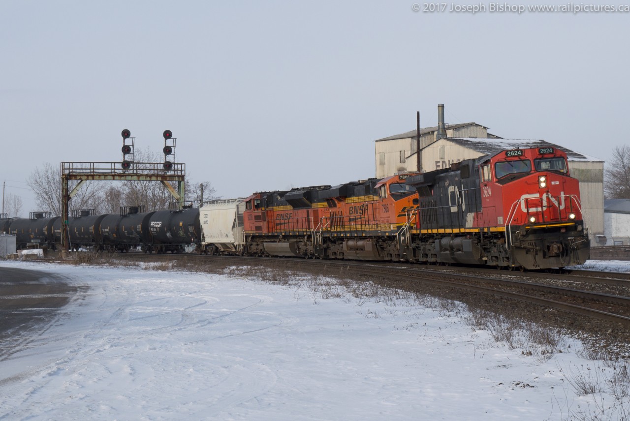 CN 394 is seen ducking under the signals at Paris Junction as they head back to their train on a bitter February morning.  Foreign Power made its first appearance on CN in 2017 in the form of BNSF 7806 and BNSF 9238 trailing the CN 2624.  Their stopping at Paris to work the North Service track allowed me to get a couple shots of the train this morning before my lectures began!