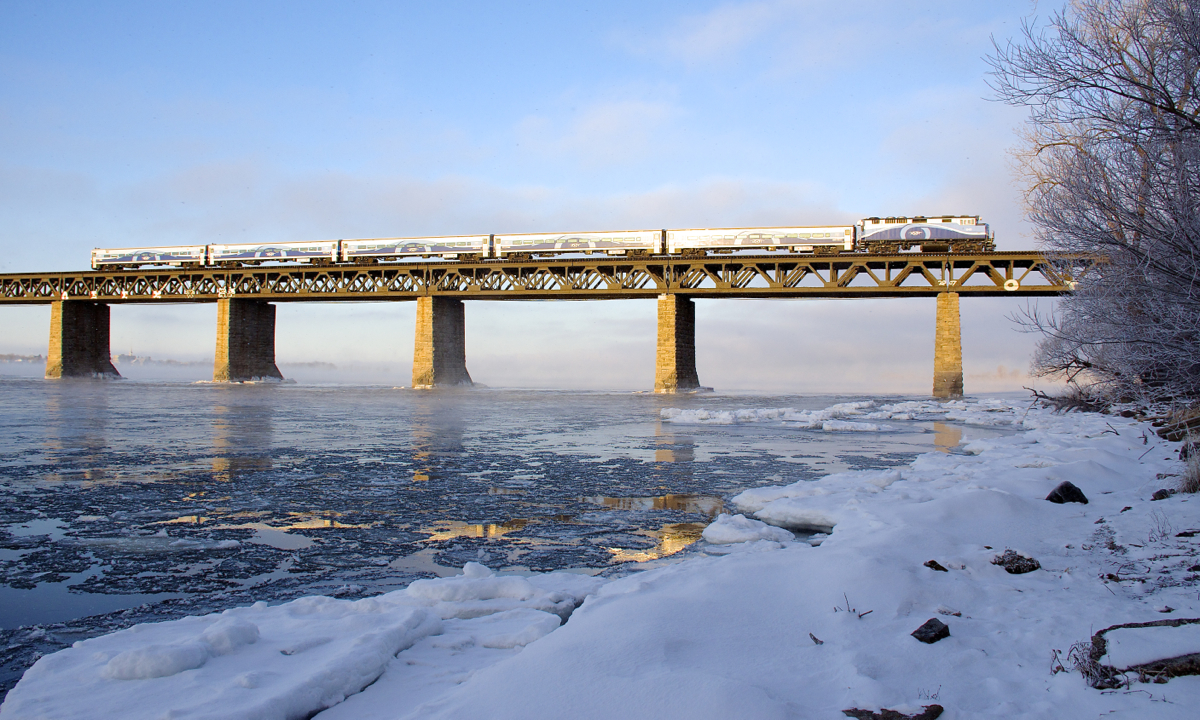 AMT 76 is nearly finished crossing the St. Lawrence River on its way to Montreal with ex-GO Transit F59PH AMT 1343 for power on a frigid morning.
