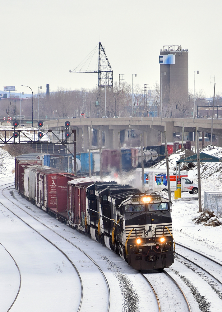 A trio of Dash9's (NS 9944, NS 9935 & NS 9679) lead a short CN 529 through a curve in Montreal West.