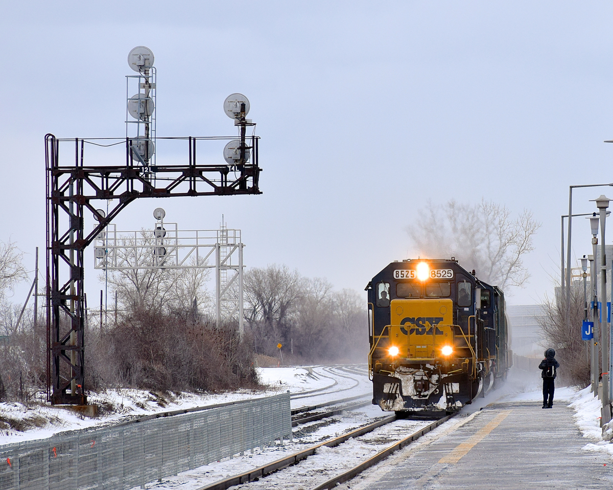 An ex-Seaboard SD50 (CSXT 8525) leads the daily CSX run-through train (CN 327) by the platform at VIA's Dorval Station. Out of sight is trailing unit CSXT 8774, an ex-Conrail SD60I.