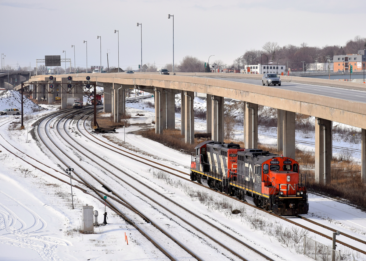 GP9's CN 7054 & CN 4102 are awaiting a signal at Turcot West before they can head west, cross over from the freight to the north track and run around their train of grain cars.