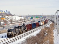 A pair of ex-Conrail Dash8's (NS 8374 & NS 8392) lead a customarily short CN 529 towards nearby Taschereau Yard. At left in the background is part of the skyline of downtown Montreal.
