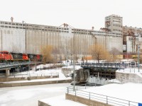 <b>Into the port in daylight for once.</b> CN 148 normally arrives into the Port of Montreal in the middle of the night, and then its power goes on CN 149 which leaves the port mid-morning. Today was an exception, with CN 148 (technically K148, it's considered a transfer as Q148 terminates in Taschereau Yard) arriving into the port a bit before noon and after CN 149 left. It has a nice lashup, with cowls CN 2452 & CN 2445 bracketing clean SD60 CN 5420 as it passes out of use grain elevator #5.