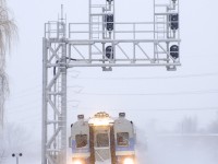With a lot of rain and warm temperatures recently, Montreal has lost just about all the snow it had, but a couple of weeks ago there was more than enough to go around as an AMT deadhead move with cab car AMT 701 leading passes under a signal gantry near Lasalle Station. The train is on its way to the South Shore to bring more commuters to downtown Montreal.