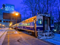 It's about half an hour after sunset as AMT 91 sits at Lucien L'Allier Station in downtown Montreal. In a few minutes the train will leave for Candiac with cab car AMT 708 leading.