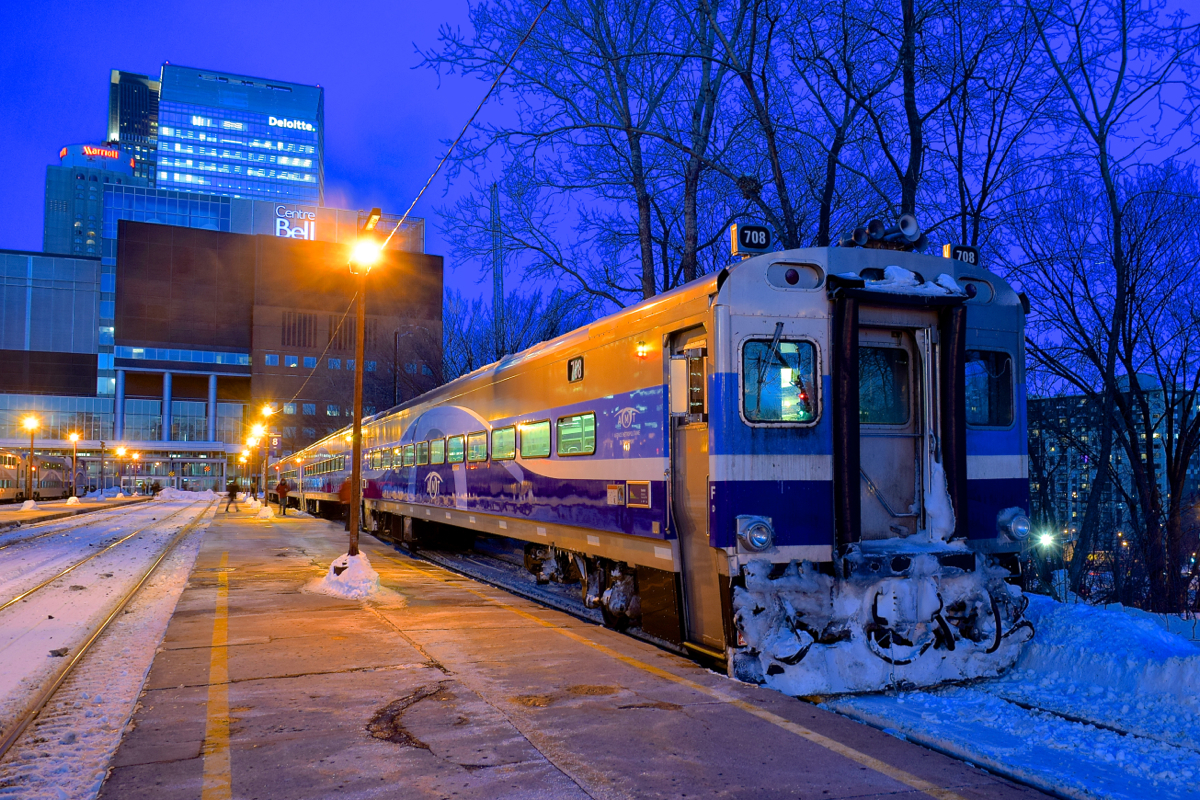 It's about half an hour after sunset as AMT 91 sits at Lucien L'Allier Station in downtown Montreal. In a few minutes the train will leave for Candiac with cab car AMT 708 leading.