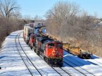 CN 120 is eastbound on CN's Montreal Sub with CN 8806, CN 5778 & CN 2279 up front and CN 8950 mid-train. While CN has been busy pulling baretables out of storage, surprisingly the ones at right were put into storage here very recently.