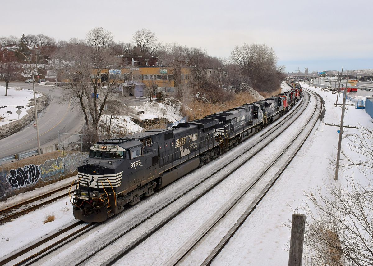 After doing a big lift at Pointe St-Charles Yard, CN 527 is en route for Taschereau Yard as it heads west through Montreal West. This train is amply powered, with seven 6-axle units (NS 9765, NS 7665, NS 7305, CN 5785, CN 2547, CN 2002 & CN 5777). The three NS units came from the previous day's CN 529 (which terminated at Southwark Yard, where CN 527 originates) whereas the the four CN units came from grain train CN 878; those 4 units were part of the pickup at Pointe St-Charles.