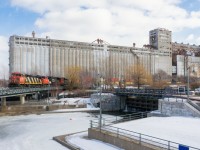 Operating as CN 596, a very late CN 148 is coming into the port of Montreal with CN 2425, CN 5664 & CN 8850 leading 14,000 feet of containers into the Port of Montreal as it passes grain elevator #5. Normally this train would arrive here in the middle of the night, but a large rainstorm last night caused high water levels in the port, necessitating that the train be tied down at Turcot West all morning.