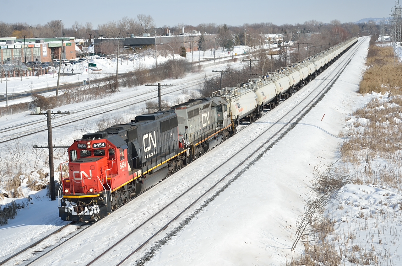 CN 585 the St-Romuald, QC to Maitland, ON Ultra-Train with its cargo of gasoline heads west through Pointe-Claire on a warm winter afternnoon.