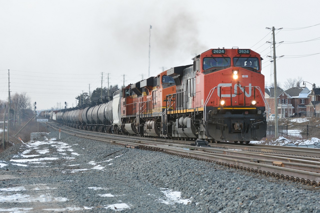 Like the old days, CN M394 once again has BNSF power as it passes CN Norval. Great change is to come once a third track is put in place. This shot may no longer be possible in the near future...