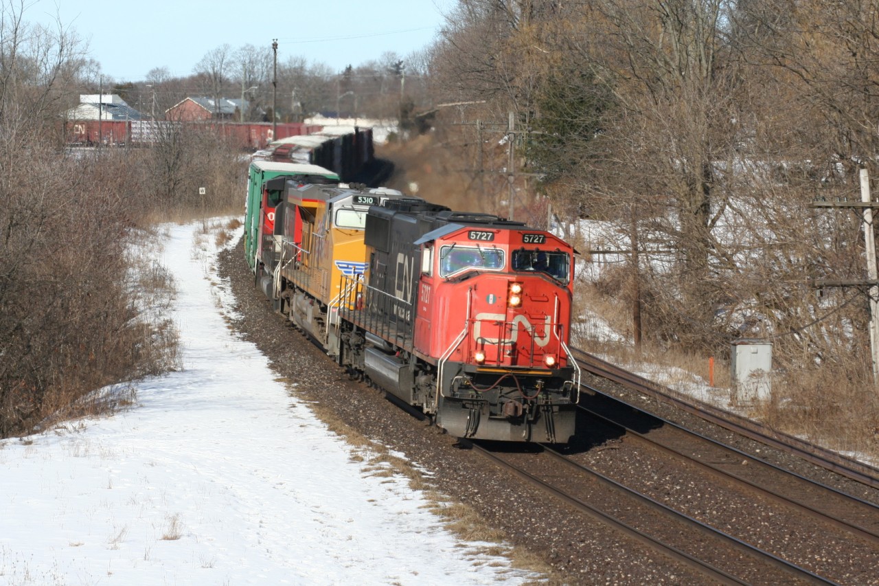CN train 302 curves through Paris, Ontario with SD75I 5727, UP GE ES44AC 5310 and GP40-2L(W) 9542.