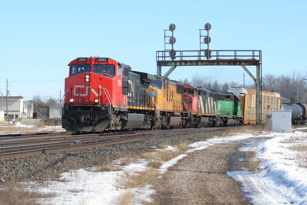 Train 397 with CN Dash 9-44CW 2685, UP SD70M 4087, Dash 8-40CM 2421 and CEFX 7111 is seen curving under the signals in Paris, Ontario.