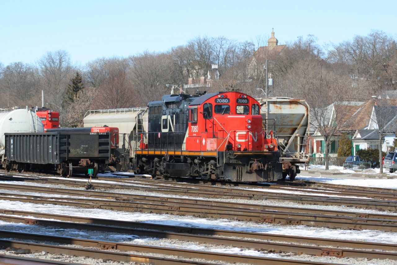 GP9RM 7080 is viewed idling away on a Sunday afternoon in the Brantford yard along with GP9RM 7210 and slug 254.