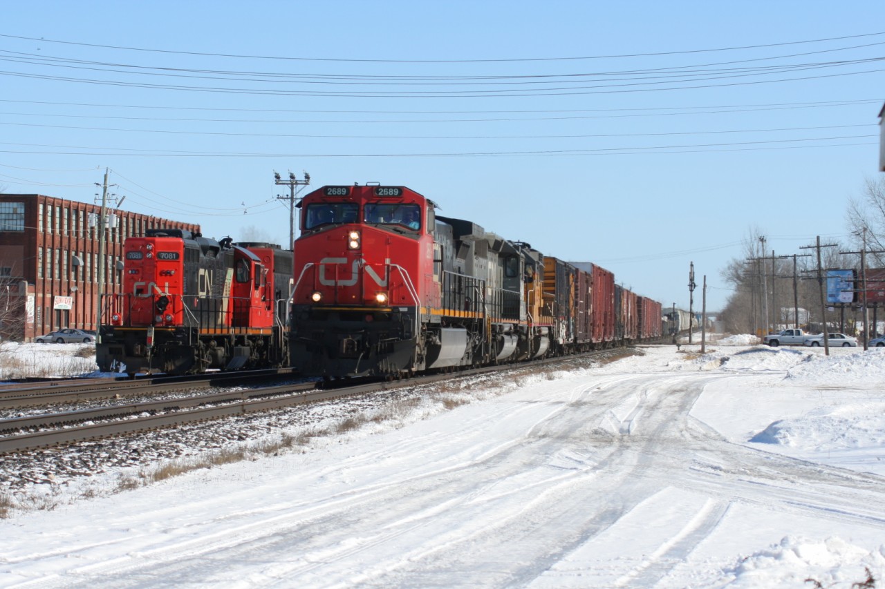 CN train 397 with Dash 9-44CW 2689, GTW SD40-3 5948 and Union Pacific GP60 2055 is seen passing train 583 with SD40-2(W) 5277 and GP9RM 7081 at Woodstock, Ontario.