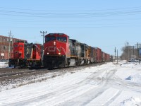 CN train 397 with Dash 9-44CW 2689, GTW SD40-3 5948 and Union Pacific GP60 2055 is seen passing train 583 with SD40-2(W) 5277 and GP9RM 7081 at Woodstock, Ontario. 