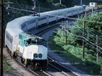 Back in the days before the bilevel cars on GO Transit, we see the evening Hamilton-bound train taking the curve at Hamilton Jct and heading toward the old CN station. Moving along just a hair too quick for my camera setting but still a presentable photo. In 1975 all GO locomotives were relieved of their 9800 series numbers, so shortly after this photo was taken, the 9811 became 703. Unfortunately I did not record the trailing unit.