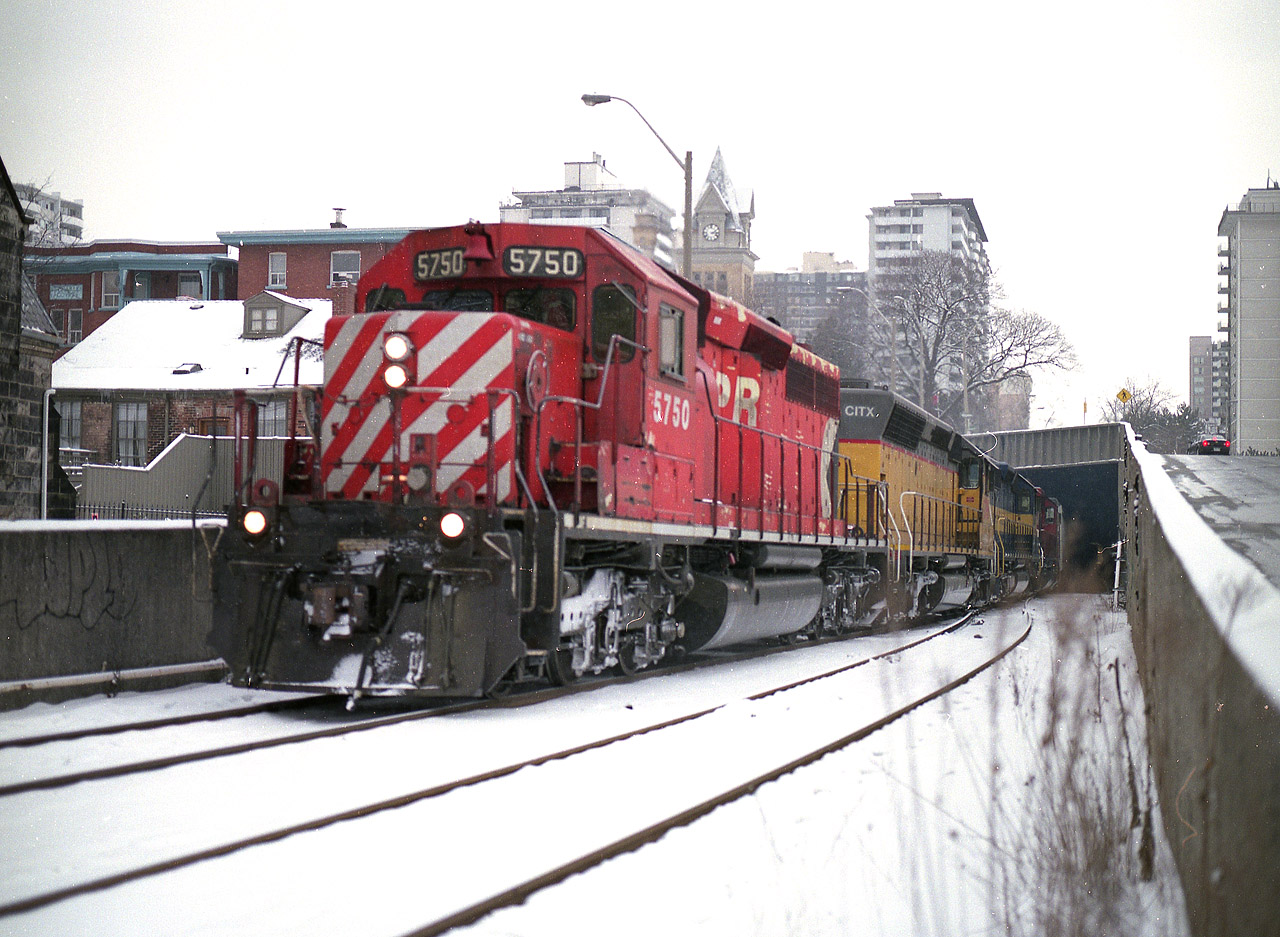 Not the easiest place to shoot. A small stepladder would be much more helpful. I'm leaning a bit over the wall in order to capture CP's #246 on its' way to Welland (and beyond) from Toronto with its colourful head end power....CP 5750, CITX 2796, ICE 6457 and CP 5917. Nice too, that the SD40-2 are making the news as of late, some coming out of hiding now that EHH has left for CSX. :o) This view is just a few hundred yards north of the gorgeous old TH&B station. Or metres, or whatever you call it now............