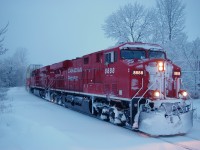 It had snowed over night and the Empress of Eights was on its return from Vancouver B.C. on its maiden voyage heading east. My three boys where just as excited as myself to see the fresh painted beauty, so bundled them up and down to the tracks we went finding a large snow pile to watch the action .