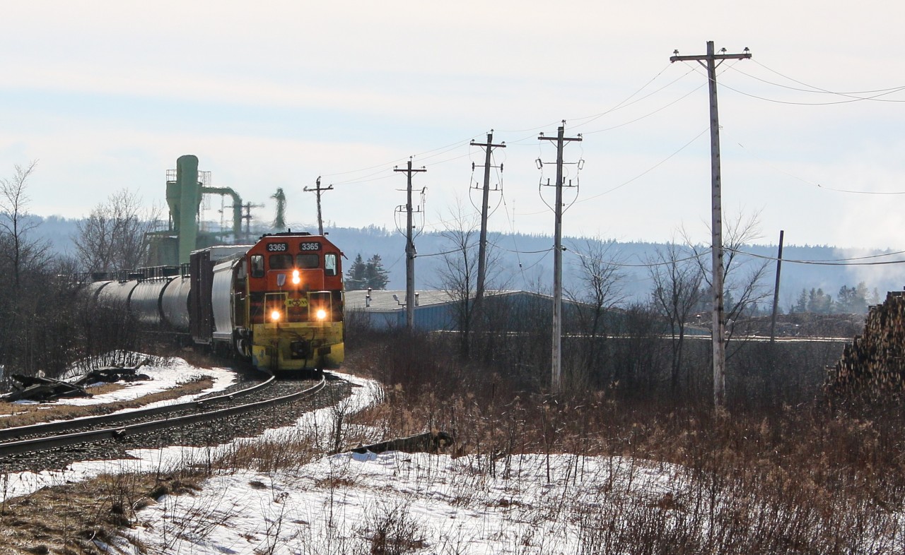 CBNS 3365 leads a train past the Irving owned Sproule lumber in valley heading towards New Glasgow