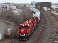 The grey weather has brought in snow flurries as Streetsville bound local T14 with a pair of former SOO Line GP38s passes the sad remains of the one time busy steel coil transfer facility in Cooksville. The early 2000s would find a new larger transfer facility built in Hamilton, making this one, once operated by Ryder redundant.