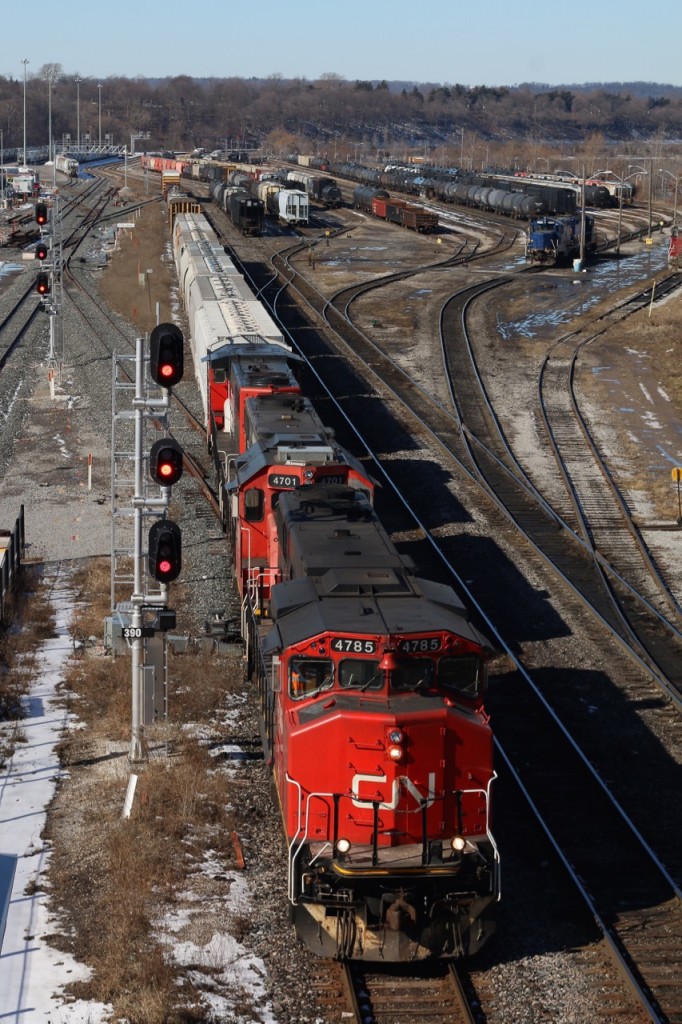 CN's local out of Aldershot is seen backing towards the new plant at Stuart after dropping cars in the SOR Hamilton yard. Today's train has a trio of GP38s up front. The crew will switch the bulk transfer facility in the background next after negotiating the switches at Stewart.